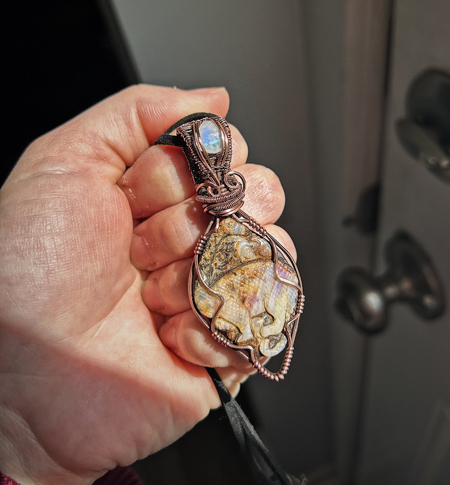 Dinosaur carved boulder opal stone pendant with moonstone accent in bale