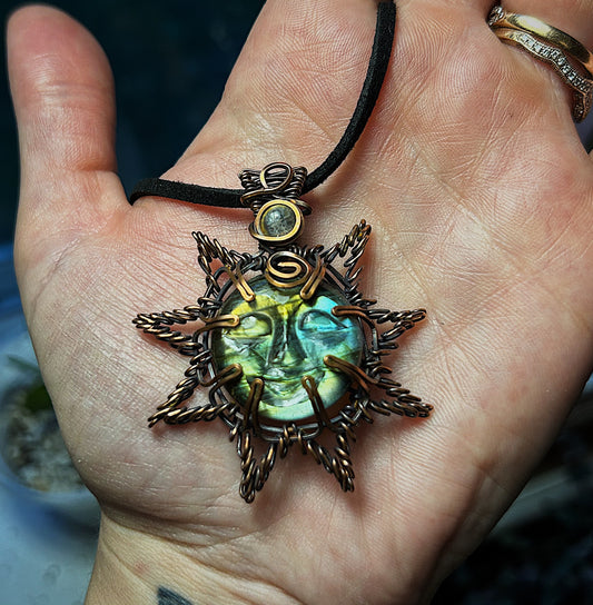 Sun pendant made from a carved labradorite, moonstone accent and oxidized copper